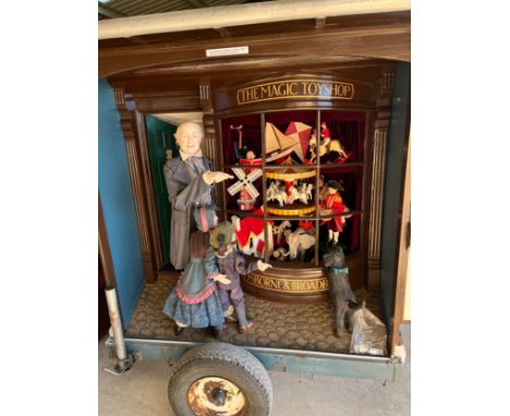 Eric Williamson - 'The Toy Shop' a large automaton group with figures and dog outside a Toy Shop, carved wood with fabric det
