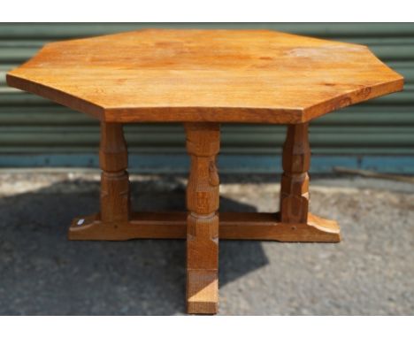 Robert Mouseman Thompson of Kilburn - an oak shaped octagonal coffee table on four octagonal and block supports, carved with 