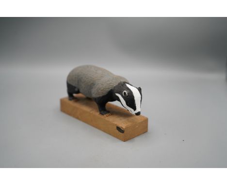 Peter Raymond Stout - a painted carved oak model of a walking Badger, on rectangular tooled top base, signed with PRS signatu