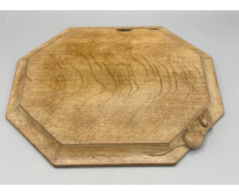 Robert Mouseman Thompson of Kilburn - an adzed oak rectangular bread board, carved with signature mouse, W30cm D25cm, with ha