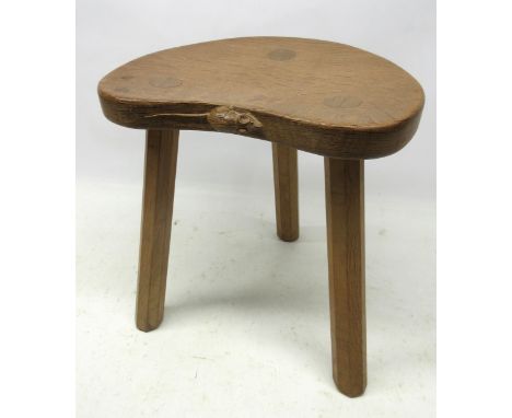 Robert Mouseman Thompson of Kilburn - an oak calf stool, dished kidney shaped top on three outsplayed octagonal supports, car