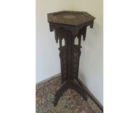 20th century Indian carved hardwood plant stand, hexagonal top on triform pierced and carved column and animal carved feet, W