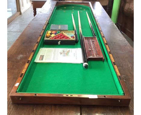 20th century mahogany folding table top bagatelle board, green baize top with edge scoreboard, with two sets of balls, three 