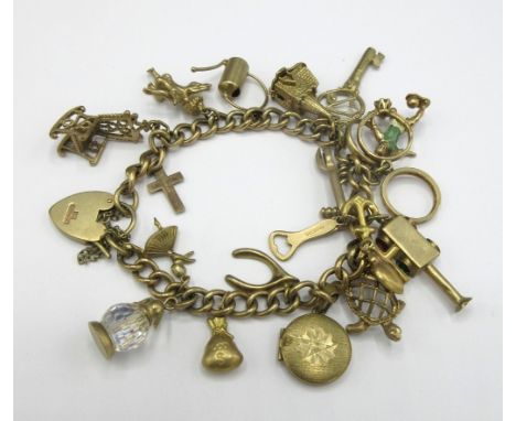 Yellow metal charm bracelet set with 9ct yellow gold charms including church, key, cherub, stamped 375, 35.66gShipping £23.00