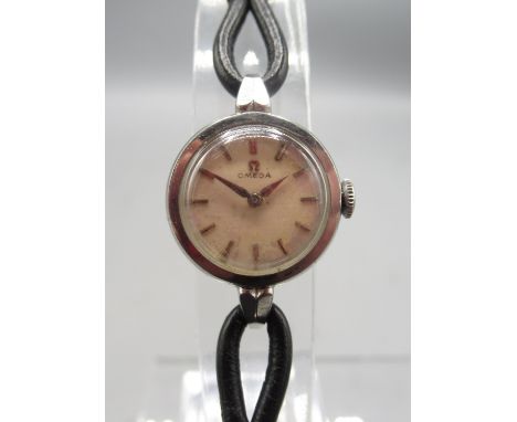 Omega ladies chrome wristwatch on cord leather strap, signed silvered dial with baton indices, signed snap on case back ref. 