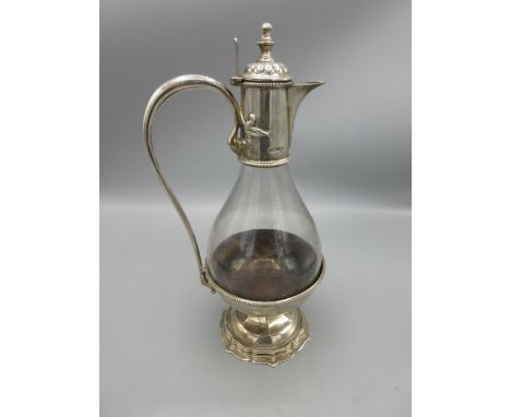 Edward V11 silver mounted pear shaped clear glass claret jug, with lobed hinged lid, scroll handle and beaded detail, on step