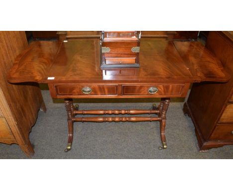 A reproduction mahogany sofa table fitted with two drawers