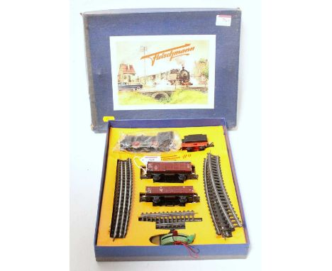 An early Fleischmann H0 ref 1000/2G goods train set in blue picture box 0-4-0 black engine and tender 2 metal wagons, track o