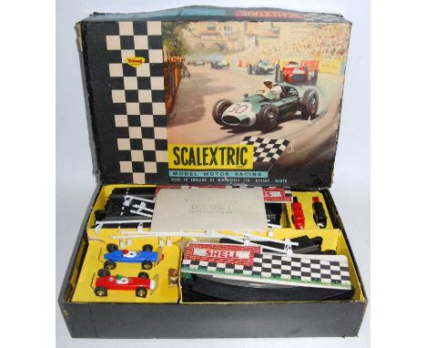 A Scalextric set No. 50 F1 Raceway playset, comprising of two cars, two throttles, various track, track barriers, instruction