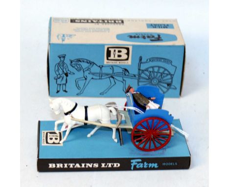 A Britains farm No. 9503 milk float comprising of white horse with blue and cream trailer fitted with red spoke hubs, complet