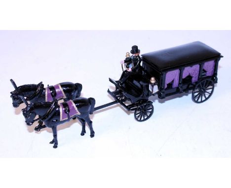 An STE Limited dated 1988 white metal horse drawn model of a four wheel hearse, finished in black with two horses with coffin