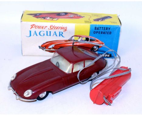 A Made in Hong Kong No. 226 plastic and battery operated model of a Jaguar E type Coupe finished in maroon with cream interio