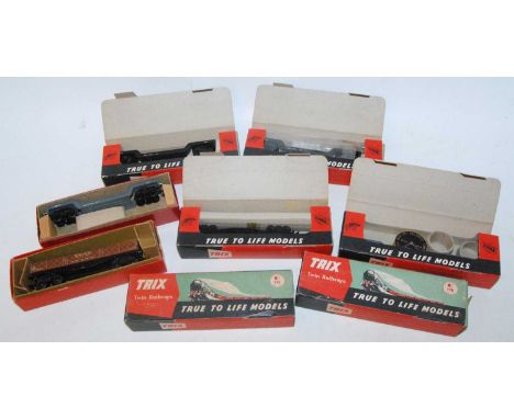 Eight Trix Twin Railway bogie Weltrol wagons with mixed loads, six in red/green picture boxes overstamped 'Caledonia Model Co