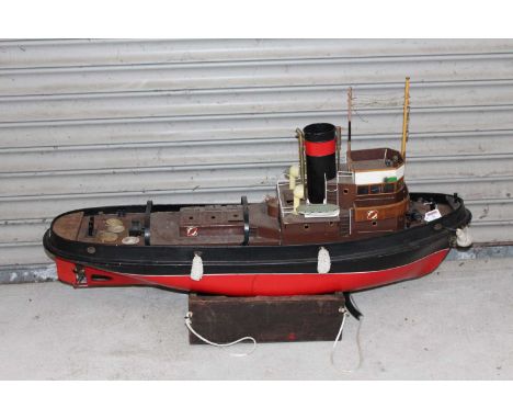 A GRP wooden kit built model of a Krakatoa tug boat comprising of red, black and white painted hull with brown removable supe