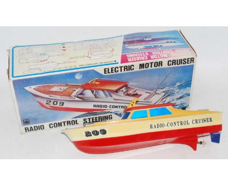 A Made in Taiwan IS Toys model of a radio controlled electric motor cruiser, finished in white, red and yellow with radio con