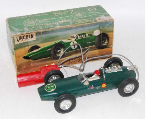 A Lincoln International plastic and battery operated model of a Lotus Indianapolis racing car finished in green with driver f