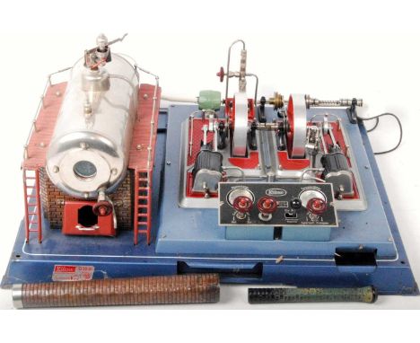 Wilesco D32 steam engine plant comprising of large tin housed horizontal boiler with safety weighted whistle, powering a twin