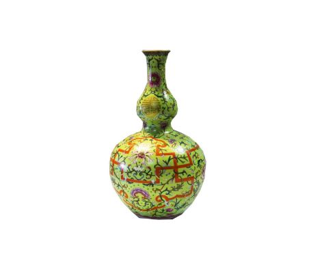 A Chinese porcelain double gourd vase, 20th century,  with intricate floral and ribbon pattern on a light green ground, seal 