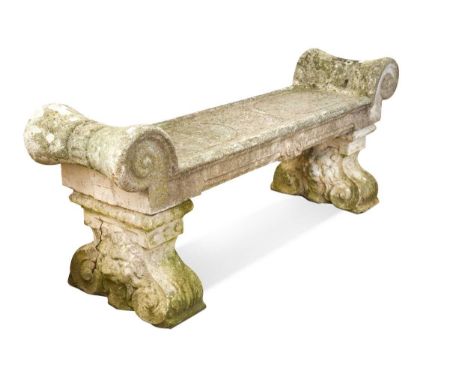 A composite stone garden bench, early 20th century, the bench with scrolled ends, the seat carved with a Celtic knot between 