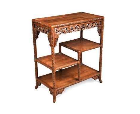 A Chinese export carved hardwood étagère, late Qing Dynasty,  the recess top with fruiting vine carved frame frieze and shelf