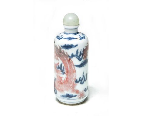 A Chinese under-glaze blue and red snuff bottle, Qing Dynasty, 19th century, with jade-type stopper and bone spatulas, the ba