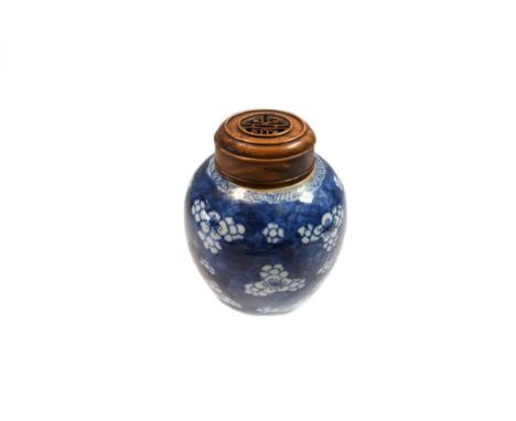 A Chinese blue and white ginger jar, Kangxi (1662-1722), with prunus and crackled ice ground, with later associated wooden co