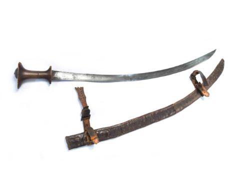 A rhinoceros horn handled North African sword, 19th century,  the sword with a curved blade and T-form grip, with a leather s