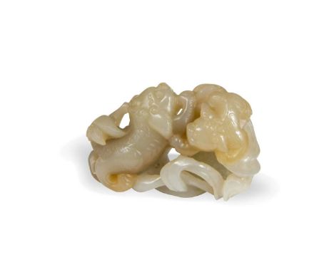 A Chinese carved jade fo dog pebble, Qing Dynasty, 19th century, a mother and cub fo dog playing among ribbons, enclosing a l