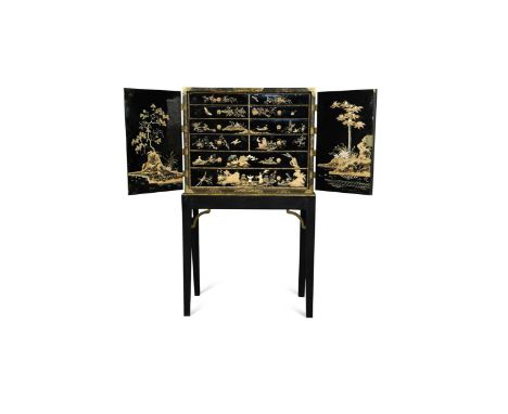 A Chinese black lacquer cabinet on later stand, 19th century, the rectangular top with foliate engraved brass mounts over a p