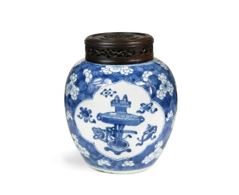 A Chinese blue and white porcelain ginger jar,  Kangxi (1662-1722), with two panels depicting Buddhist emblems on a prunus an