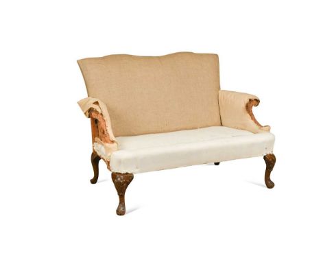 A George II style two-seater sofa, twin arched back over outscrolling arms raised on cabriole legs with carved acanthus detai