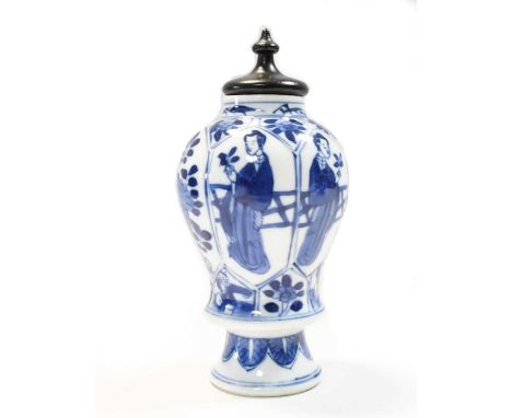 A Chinese blue and white porcelain footed bottlevase, Kangxi (1662-1722), painted with lange lijzen and playful boys, with a 