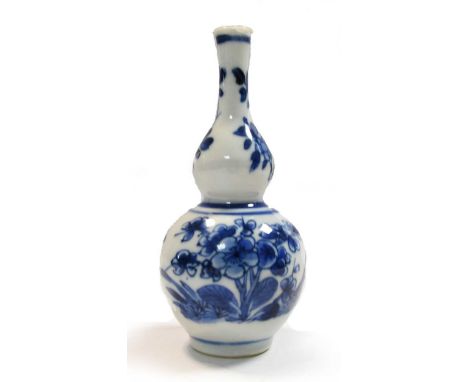 A Chinese blue and white double gourd vase, Kangxi (1662-1722), decorated with blossoms and swags of flowers13cm highGood ove