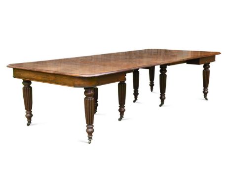 A mahogany extending dining table stamped 'GILLOWS', 19th century, with three additional leaves, the rounded rectangular top 