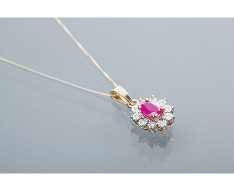 RUBY AND DIAMOND CLUSTER PENDANT
the central oval ruby measuring approximately 5.80 x 4.07mm, surrounded by a row of brillian