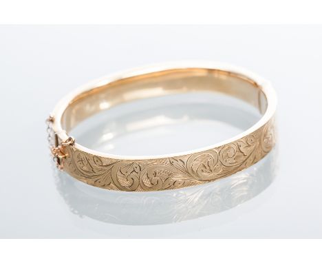 NINE CARAT GOLD BANGLE
engraved with scrolling decoration, hallmarked nine carat gold, 14.5g