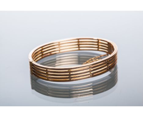 EDWARDIAN NINE CARAT GOLD BANGLE
of pierced form, marked for nine carat gold, 13.2gms