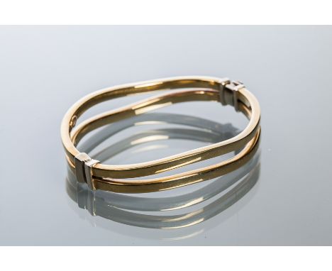 NINE CARAT GOLD BANGLE
designed with two curved bars, marked 375, 18.7g