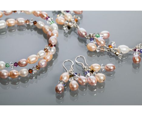 SILVER FRESHWATER PEARL AND SWAROVSKI CRYSTAL NECKLACE, EARRINGS AND BANGLE  SET
with ovoid pearls in varying tones of pink, 