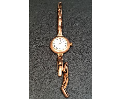 LADIES VINTAGE NINE CARAT GOLD ROLEX WRISTWATCHthe white enamel dial with Roman numerals, the case and movement marked Rolex,
