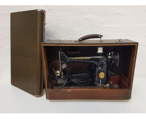 VINTAGE SINGER SEWING MACHINEin a fitted carry case with power lead and foot pedal, together with instruction manual 