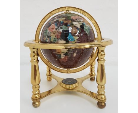 TABLE TOP TERRESTRIAL GLOBEwith a brass frame and specimen stone globe, the base with an inset compass, 27cm high 