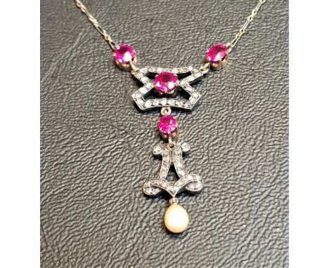 RUBY AND DIAMOND SET NECKLACEthe drop pendant section with one oval cut and three round cut rubies surrounded by small diamon