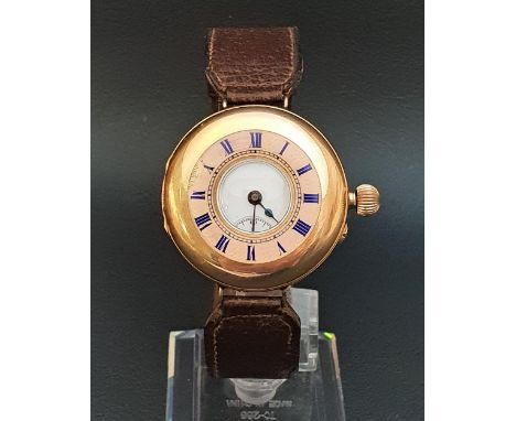 CONTINENTAL TWELVE CARAT GOLD HALF HUNTER WRISTWATCHthe white enamel dial with Roman numerals and subsidiary seconds dial, th