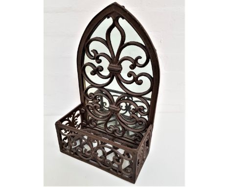 DECORATIVE IRON FRAME WALL MIRRORof arch design with a fleur de lis pattern and decorative front facing pierced basket, 45cm 