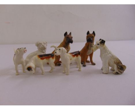 Seven ceramic figurines of dogs to include a variety of pedigrees