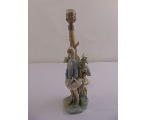 A Lladro table lamp figural group on naturalistic base