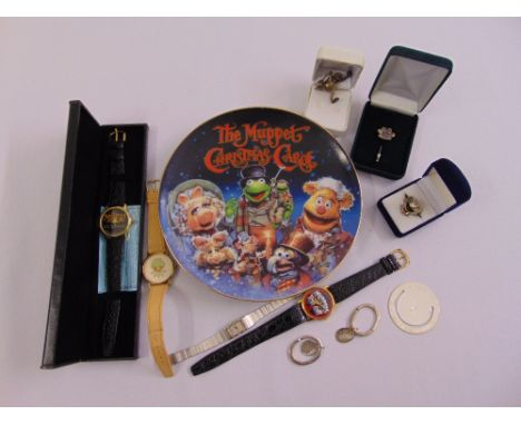 A quantity of entertainment collectables to include watches, a ring, a bookmark and a Muppet Xmas plate