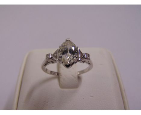 Platinum and diamond ring flanked by diamonds to the shoulders, the central diamond approx 1ct