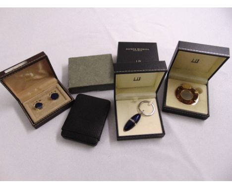 A quantity of Dunhill gentlemans collectables to include a key ring, a cigar cutter, cufflinks and a card case, in original p